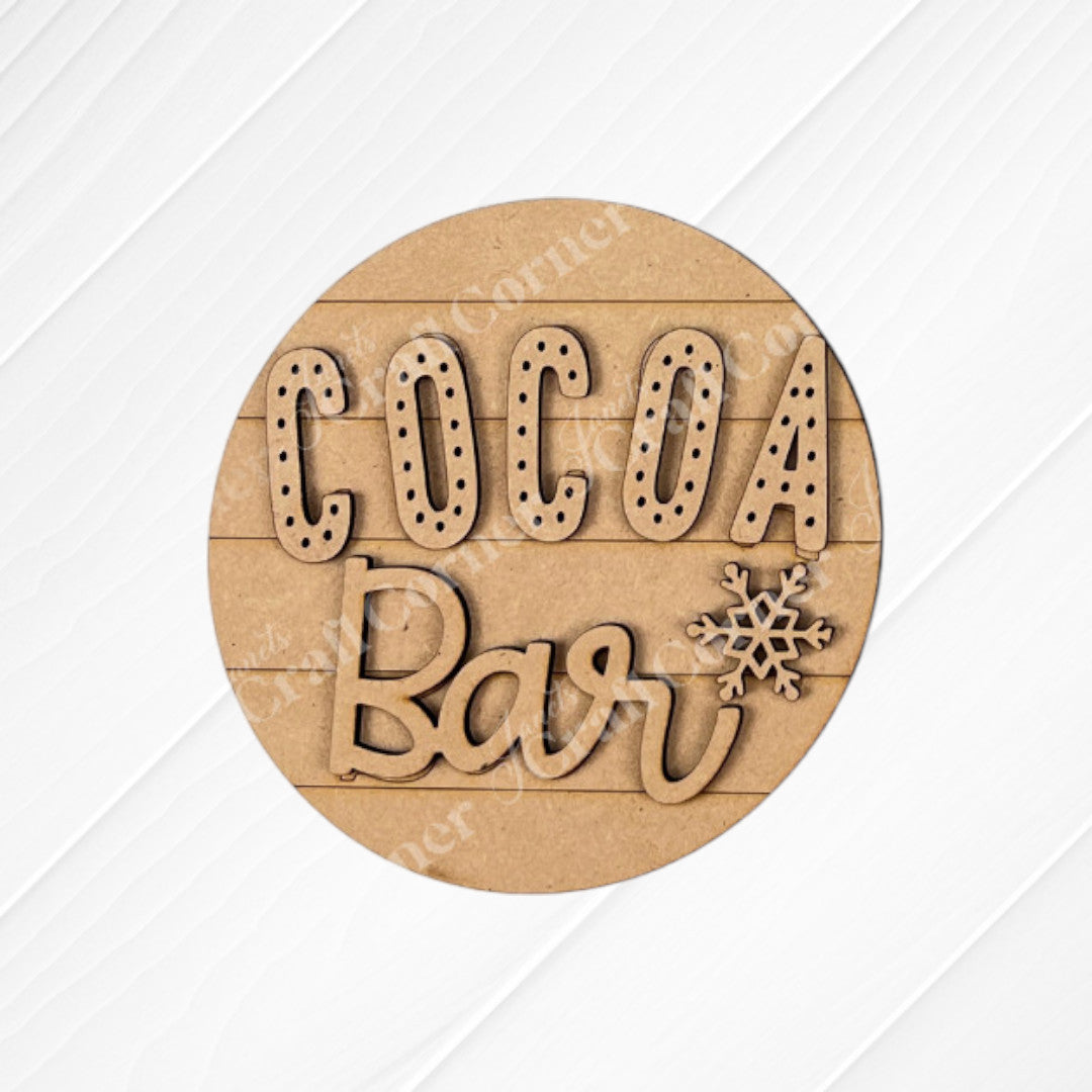 Cup of Cheer Hot Cocoa Mini Shelf Sitters by Janet's Craft Corner is a DIY seasonal home decor craft kit featuring "COCOA Bar" cutout letters and a snowflake—perfect hot cocoa decor for cozy homes. Set includes 1 piece.