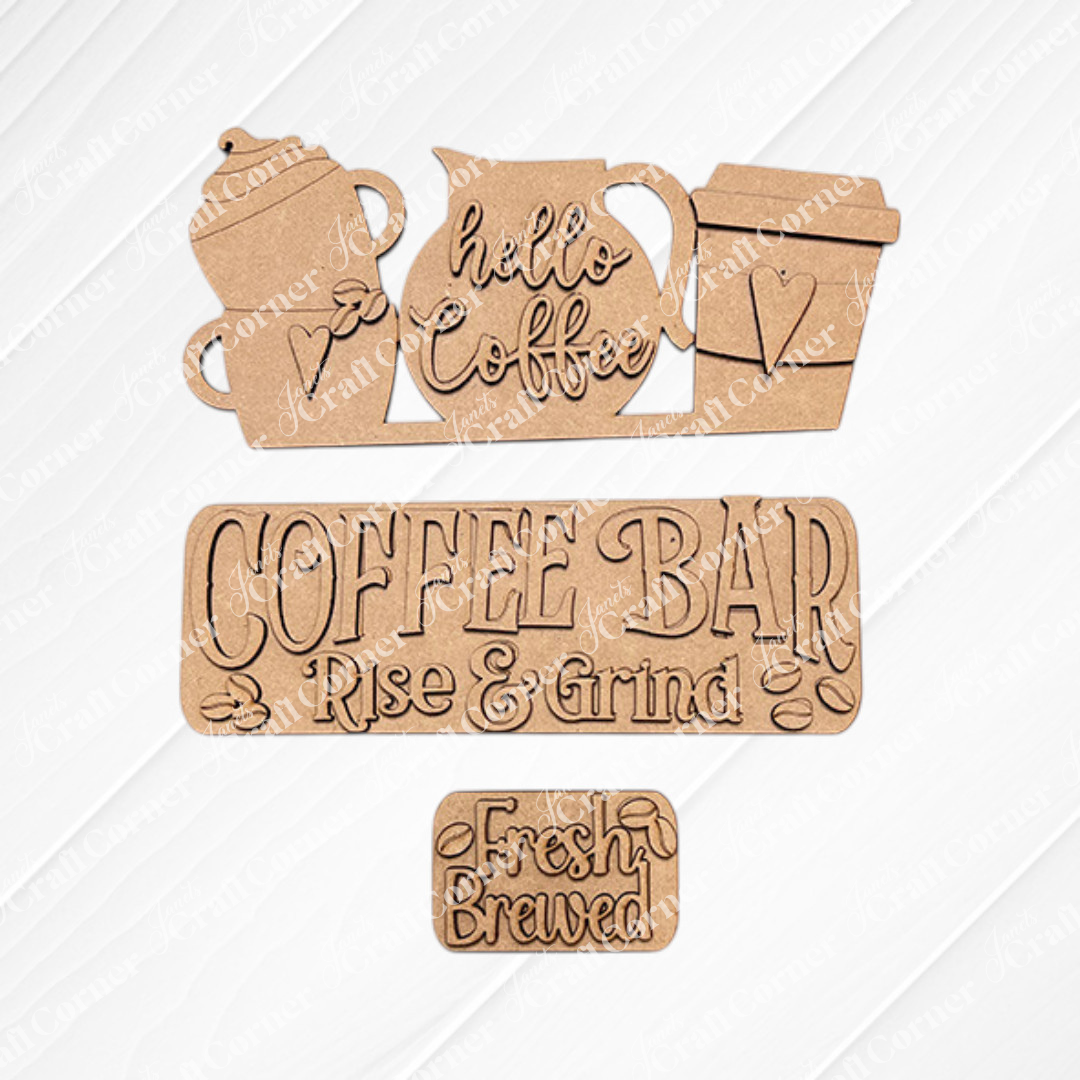The Coffee Bar Interchangeable Insert from Janet's Craft Corner is a DIY home decor kit featuring hand-painted coffee-themed cutouts. It includes a teapot and cups with "hello Coffee," a "COFFEE BAR" sign with "Rise & Grind," and a small "Fresh Brewed" sign, all set against textured white tiles. Beautifully arranged on burlap fabric, these inserts are perfect for adding charm to your space.