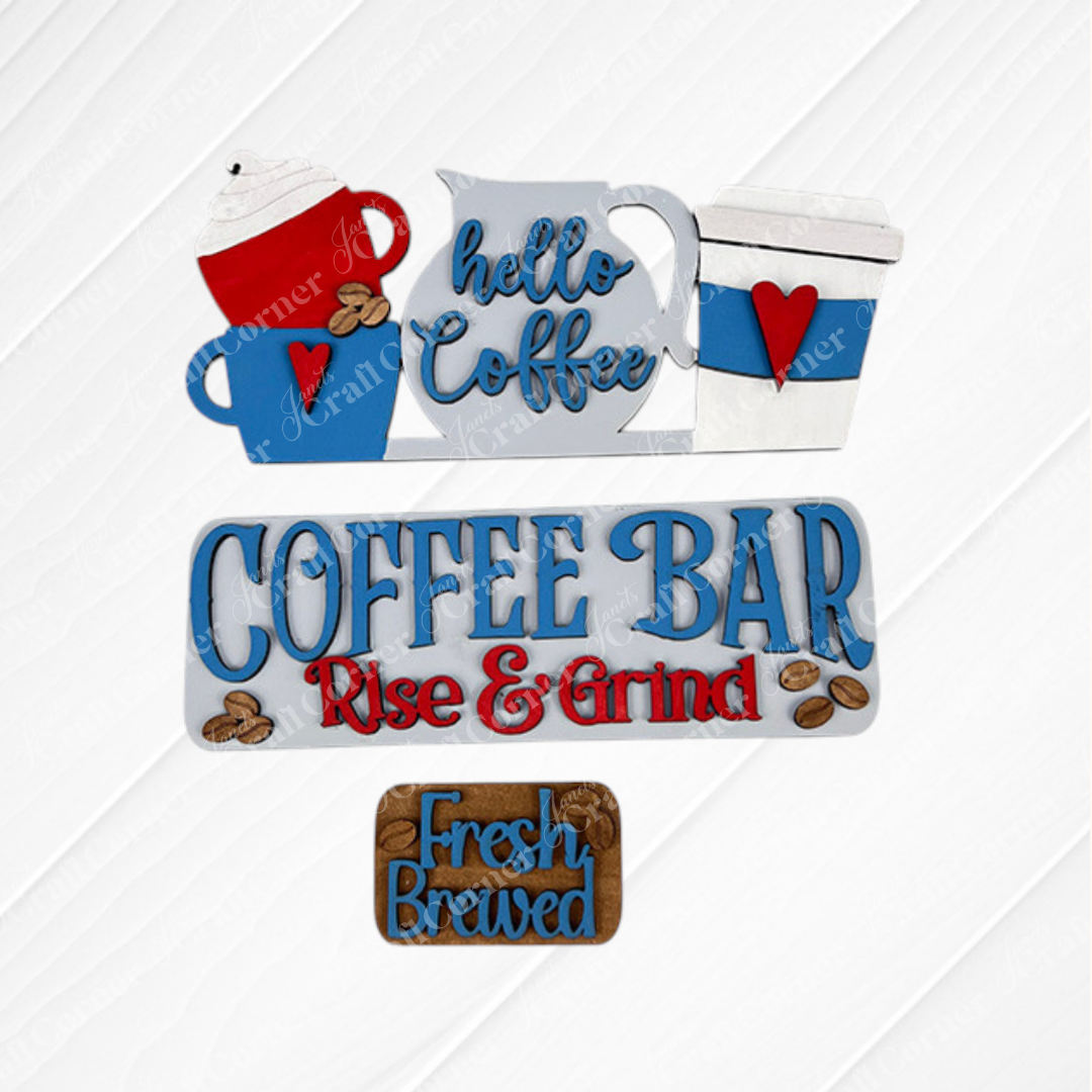 Textured background featuring wooden coffee-themed signs including "Hello Coffee" with blue cups and "Coffee Bar Rise & Grind" in blue and red, offers interchangeable craft inserts for a touch of variety. The "Fresh Brewed" sign is presented on a brown plaque adorned with coffee bean illustrations, resembling a hand-painted DIY craft kit from Janet's Craft Corner's Coffee Bar Interchangeable Insert collection.