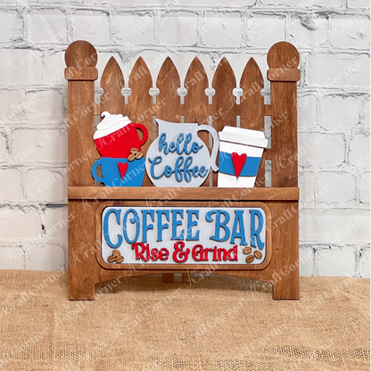 This delightful wooden sign from Janet's Craft Corner, resembling a classic picket fence, showcases coffee-themed designs with cups and a pot. It reads "Hello Coffee" and "COFFEE BAR Rise & Grind," set against a white brick background on burlap, ideal for DIY craft kit enthusiasts.