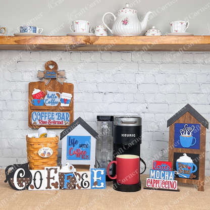 Janet's Craft Corner's Coffee Swappable Squares feature charming wooden signs on burlap with Life Happens Coffee Helps" and "Rise & Grind" designs in a coffee bar setting with other decor items, perfect for DIY seasonal home decor in small spaces against a white brick wall.