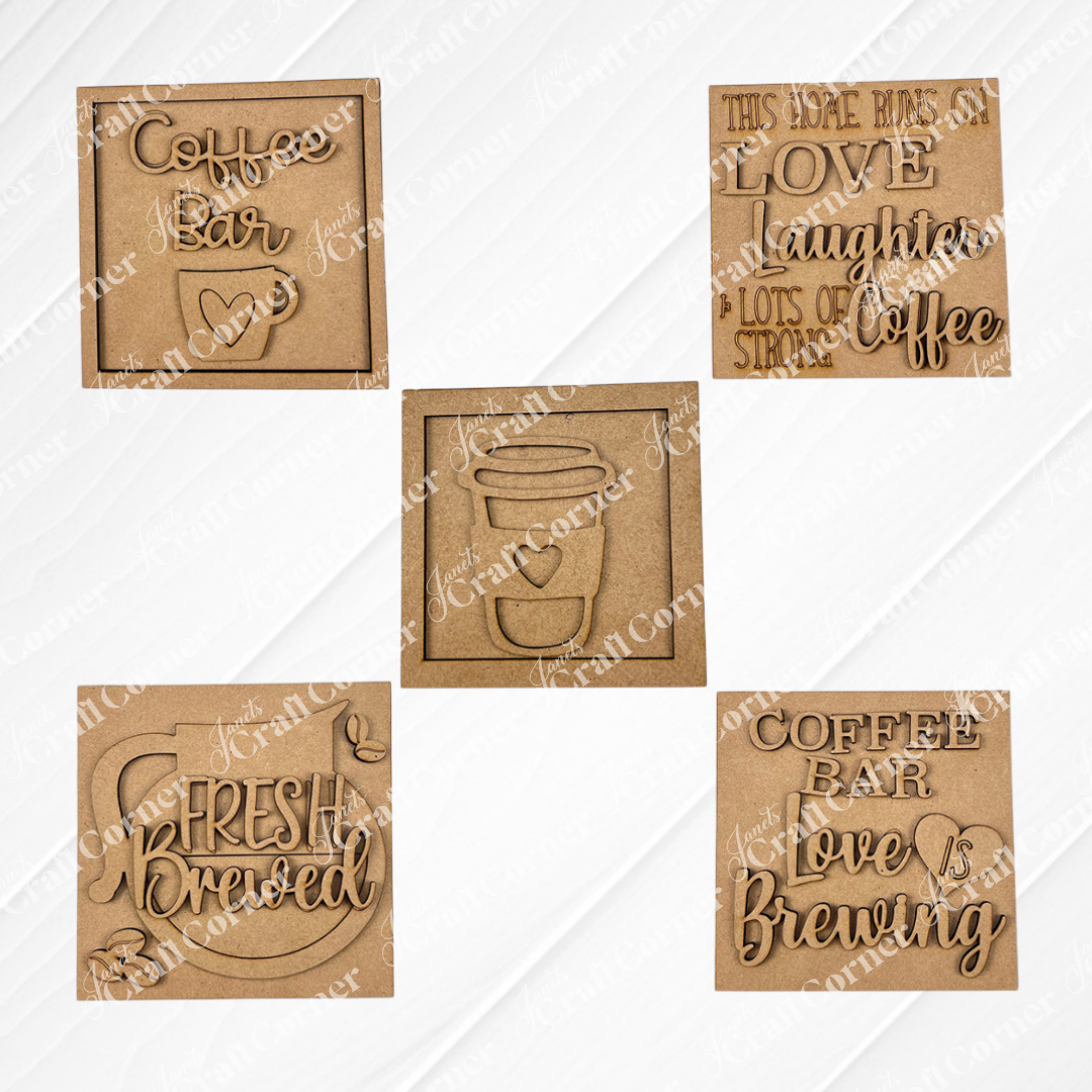 Set of five "Coffee Bar Swappable  Squares" by Janet's Craft Corner—square and rectangular wooden plaques with coffee-themed designs like "Love, Laughter, Coffee." Ideal for DIY home decor or adding charm to small spaces. Displayed on a white background.