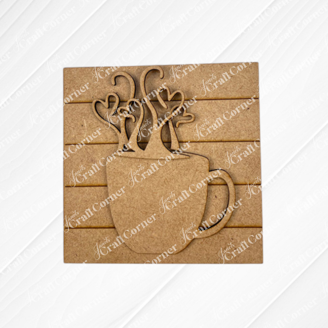 Janet's Craft Corner Coffee Swappable Squares is a DIY seasonal home decor craft kit featuring a wooden coffee mug cutout with heart steam, set on a square slatted background—ideal for coffee lovers and creative projects.