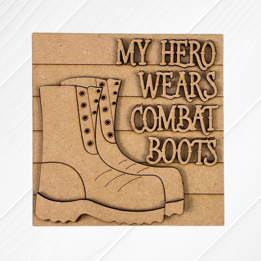 The Military Squares by Janet's Craft Corner feature wood cut-outs of combat boots and the engraved words "MY HERO WEARS COMBAT BOOTS" on a light wooden plaque—perfect for tiered tray decor or Swappable Squares displays.
