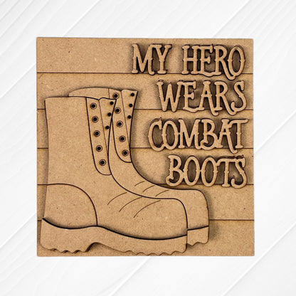 The Military Squares by Janet's Craft Corner feature wood cut-outs of combat boots and the engraved words "MY HERO WEARS COMBAT BOOTS" on a light wooden plaque—perfect for tiered tray decor or Swappable Squares displays.