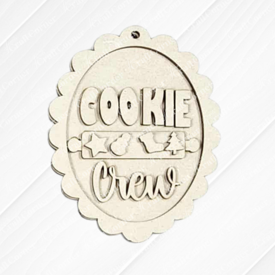 Janet's Craft Corner's Christmas Baking Ornaments DIY kit features a scalloped-edge wooden ornament reading "Cookie Crew" with star, mitten, and tree cutouts—perfect for festive holiday décor. Choose from 5 designs!.