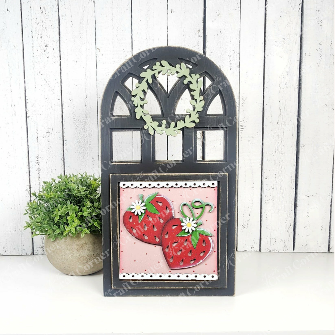 Add charm to your home with Janet's Craft Corner’s Strawberry Swappable Squares DIY kit—a black arched frame, green leaf wreath, and a square panel with red strawberries and white flowers make perfect tiered tray decor.