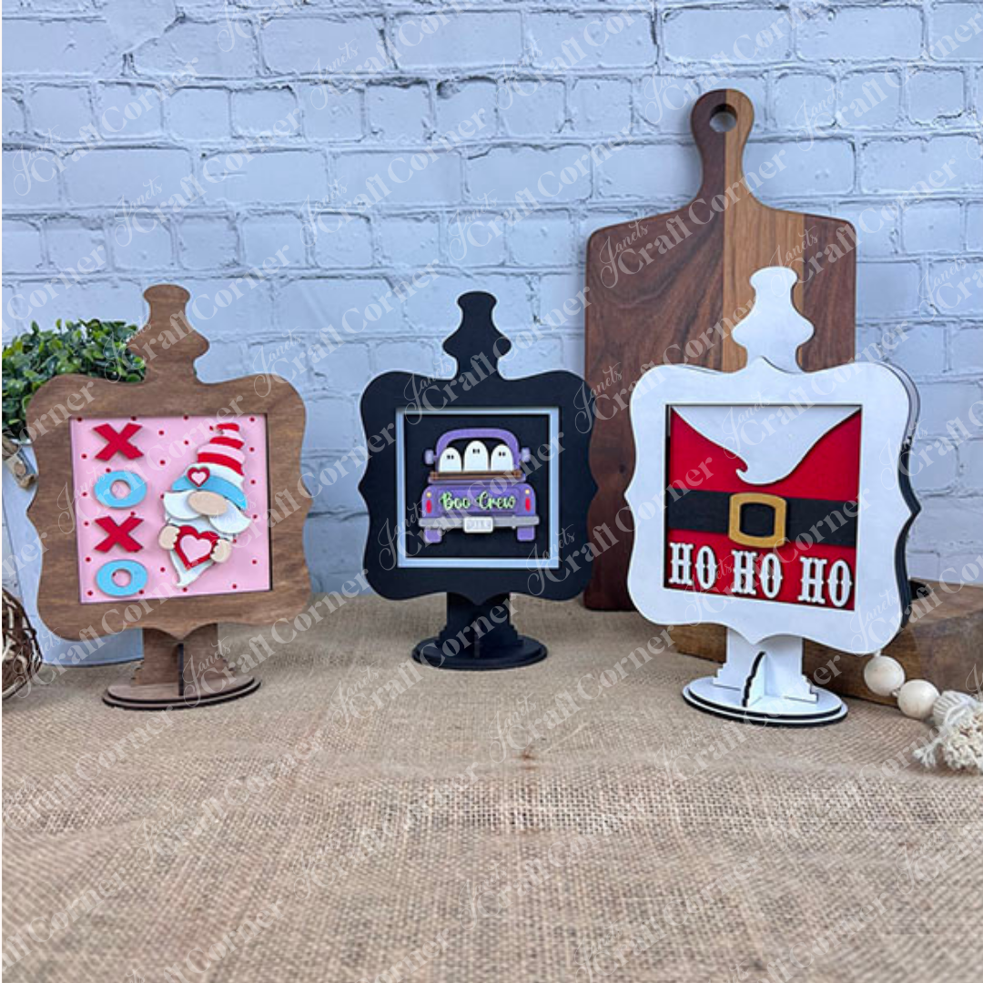 The Heartland Drop In Swappable Squares Holder DIY Craft Kit lets you display festive wood square inserts for Valentine's, Halloween, and Christmas on a burlap-covered table. Set of 1 is perfect for customizable seasonal home décor against any backdrop.