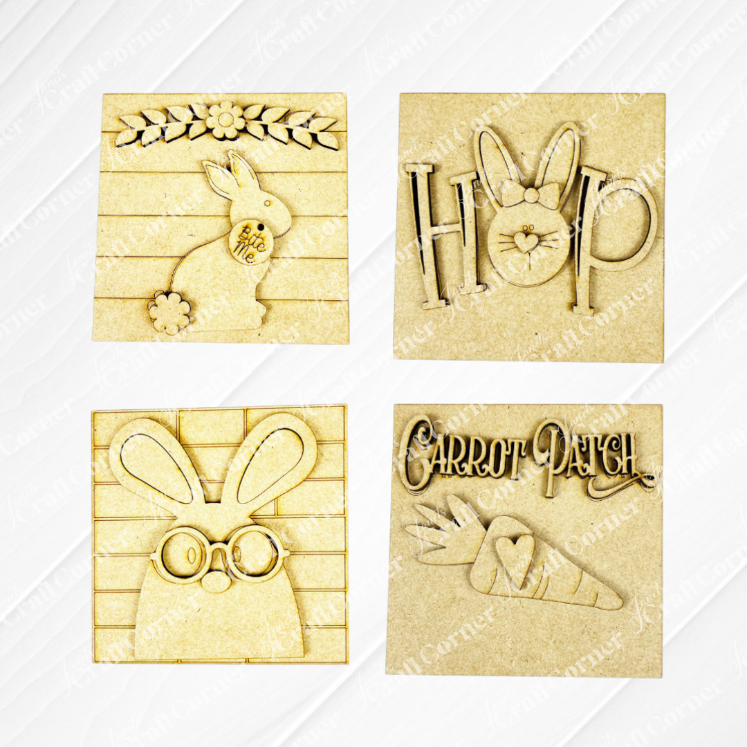 Janet’s Craft Corner Easter Bunny Squares include four rustic wood plaques with cut-outs: a floral bunny, “HOP” with ears, a bunny with glasses, and “Carrot Patch” with carrots—perfect for tiered trays or as Swappable Squares.