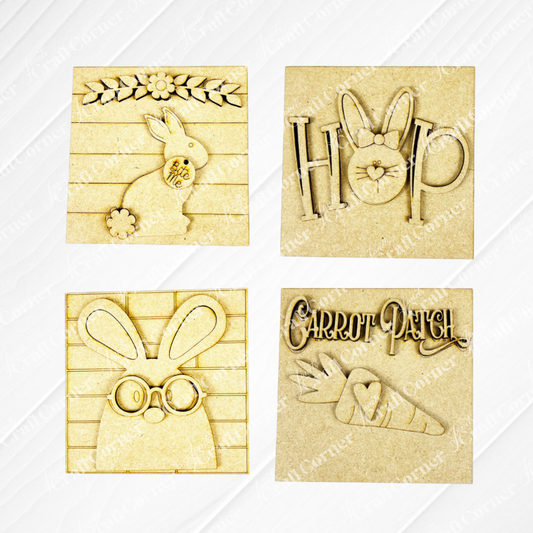 Janet’s Craft Corner Easter Bunny Squares include four rustic wood plaques with cut-outs: a floral bunny, “HOP” with ears, a bunny with glasses, and “Carrot Patch” with carrots—perfect for tiered trays or as Swappable Squares.