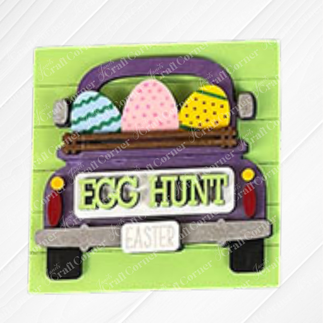 The "Hello Easter Squares" by Janet's Craft Corner shows a purple truck with an "EASTER" license plate carrying three colorful eggs. The tailgate says "EGG HUNT." Set on a light green, wood-textured background—perfect for coffee-inspired decor.