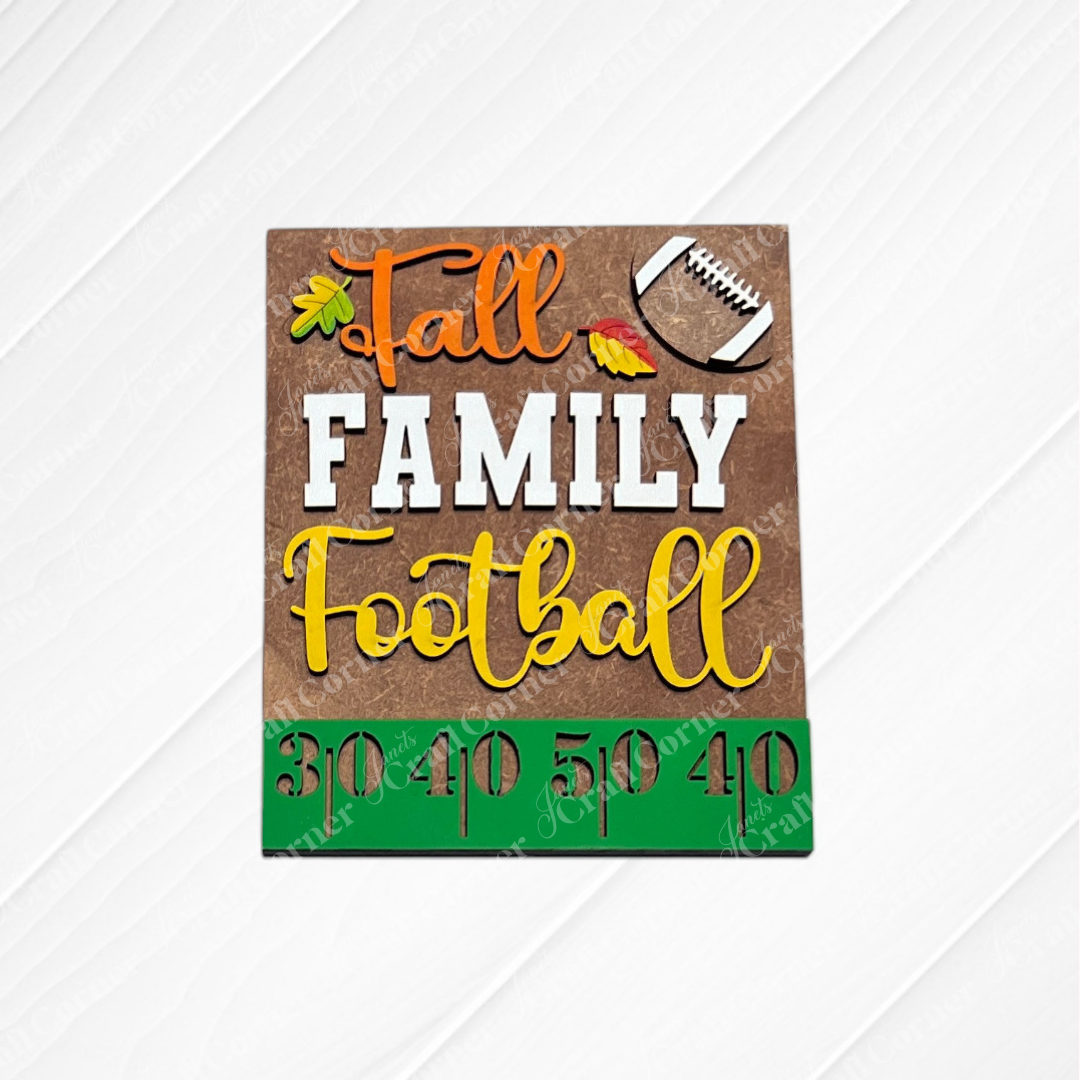 Janet’s Craft Corner Football Farmhouse Signs feature a white wood background with the phrase “Fall Family Football,” adorned with a football graphic, autumn leaves, and green yard numbers—30, 40, 50, 40. Designed as a switchable farmhouse sign, it’s perfect for interchangeable seasonal displays or incorporating into your favorite DIY home decor kit.