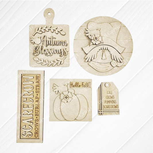 Janet's Craft Corner Fall Scarecrow Mini Shelf Sitters DIY craft kit includes five unfinished wood cutouts: Autumn Blessings, scarecrow face, pumpkin, Hello Fall!, and a scarecrow tag—perfect for autumn home decor. Set of 1.