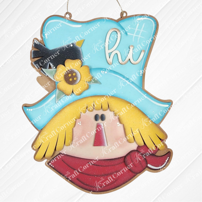 Add a festive touch with Janet's Craft Corner Fall Scarecrow Door Hanger! This DIY seasonal home decor craft kit (set of 1) features a scarecrow head with blue "hi" hat, straw hair, red scarf, and a black bird—perfect for fall decorating.