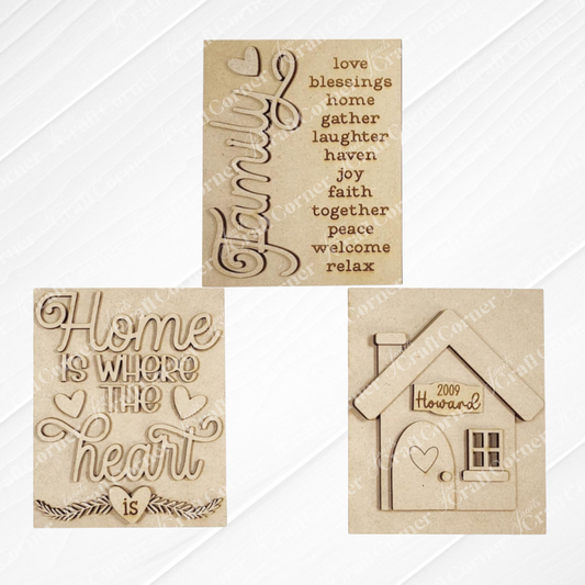 The Family-Home Farmhouse Signs DIY craft kits by Janet's Craft Corner. Three options are available: one with “Family” and uplifting words, another with “Home is where the heart is,” and a third featuring a house with a heart in the door.