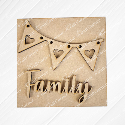 Janet's Craft Corner’s Family Home Squares features a wooden triangular bunting with heart shapes and “Family” in cursive below—perfect as tiered tray decor against a plain background.