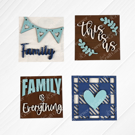 Janet's Craft Corner Family Home Squares: four wooden signs with blue accents—"Family" heart banner, "this is us" with blue leaves, "Family is Everything," and a blue heart on a geometric background. Perfect tiered tray decor!.