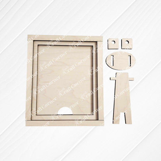 A wooden geometric figure resembling a person is positioned beside the Janet's Craft Corner Farmhouse Frame for Interchangeable Signs, which features two smaller circles on top. Set against a white, horizontally-lined background, this perfect addition to farmhouse decor has a round head with notches for eyes and mouth.