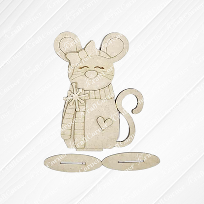 The Forest Friends Shelf Sitters DIY kit by Janet's Craft Corner features a light brown cartoon mouse with a bow, scarf, heart detail, and star wand. Includes two oval pieces. Choose from 3 cute seasonal designs for fun home decor crafting.
