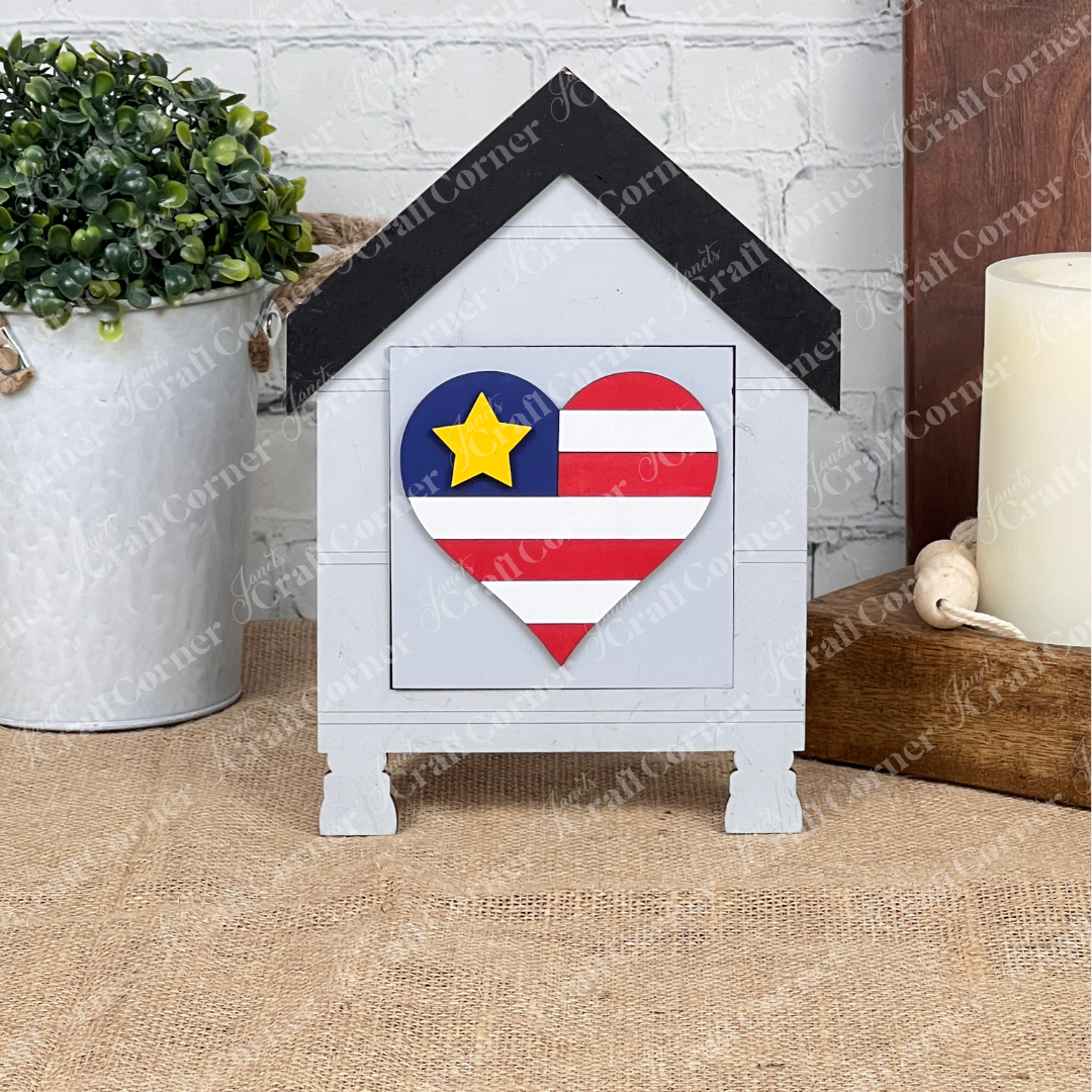 Military Squares by Janet's Craft Corner—a small, house-shaped wood cut-out with a heart in Texas flag colors on the front—makes a charming addition to tiered tray decor.