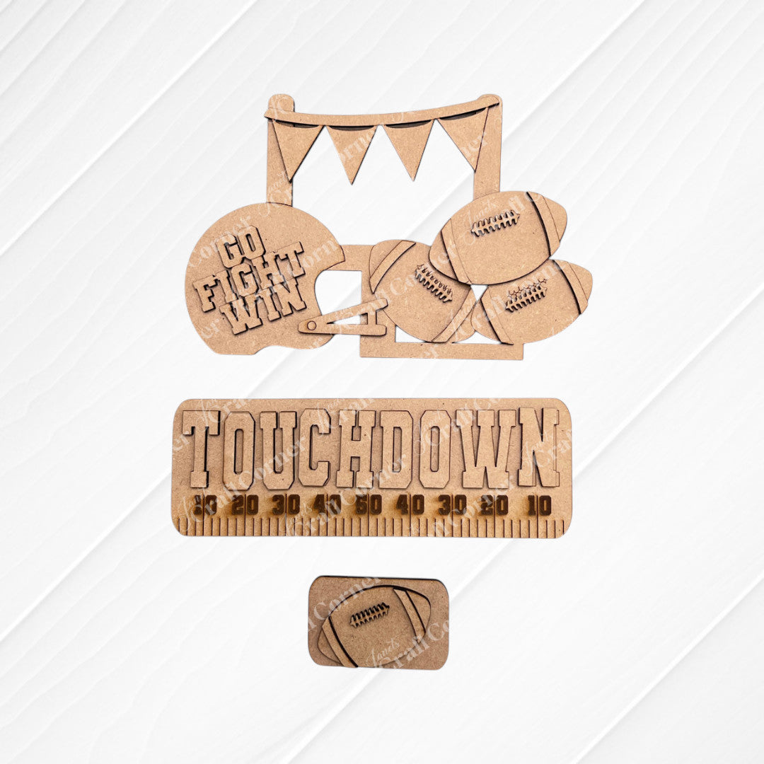 Transform your space with Janet's Craft Corner's Football Interchangeable Insert DIY home decor kit. This hand-painted set features wooden cutouts, including a football helmet inscribed with "Go Fight Win," four footballs, and a “Touchdown” sign above a yard line. It also comes with an additional smaller football insert at the bottom – perfect for adding a personalized touch to your decor.