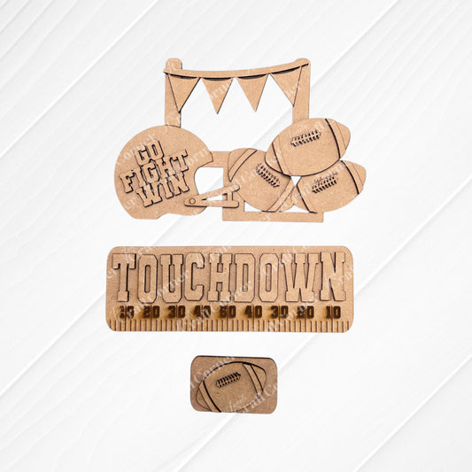 Transform your space with Janet's Craft Corner's Football Interchangeable Insert DIY home decor kit. This hand-painted set features wooden cutouts, including a football helmet inscribed with "Go Fight Win," four footballs, and a “Touchdown” sign above a yard line. It also comes with an additional smaller football insert at the bottom – perfect for adding a personalized touch to your decor.