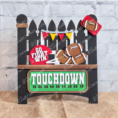 Introducing the Football Interchangeable Insert DIY home decor kit by Janet's Craft Corner: This adorable garden fence set showcases football-themed red & gold accents, including interchangeable footballs, helmets with "Go Fight Win," a goalpost, and a "Touchdown" sign. Perfectly set against a white brick wall backdrop, it offers an ideal project for hand-painted DIY craft enthusiasts looking to add a personal touch to their decor.