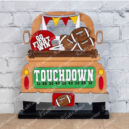 Introducing the Football Interchangeable Insert DIY home decor kit by Janet's Craft Corner: This charming copper  truck set showcases football-themed red & gold accents, including interchangeable footballs, helmets with "Go Fight Win," a goalpost, and a "Touchdown" sign. Perfectly set against a white brick wall backdrop, it offers an ideal project for hand-painted DIY craft enthusiasts looking to add a personal touch to their decor.