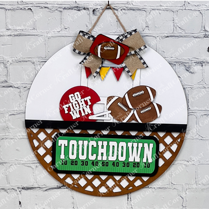 Introducing the Football Interchangeable Insert DIY home decor kit by Janet's Craft Corner: This charming door hanger set showcases football-themed accents, including interchangeable footballs, helmets with "Go Fight Win," a goalpost, and a "Touchdown" sign. Perfectly set against a white brick wall backdrop, it offers an ideal project for hand-painted DIY craft enthusiasts looking to add a personal touch to their decor.