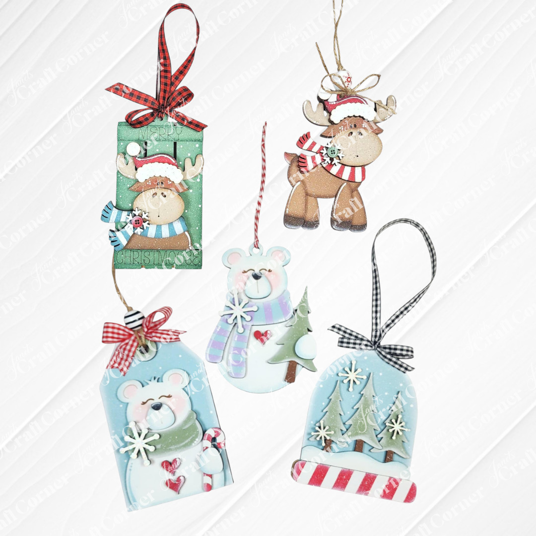Forest Friends Ornaments - DIY craft kits by Janet's Craft Corner let you create 5 pastel animal ornaments with red accents—each featuring festive bears, a reindeer, trees, and snowflakes, all designed to hang with ribbon or string.