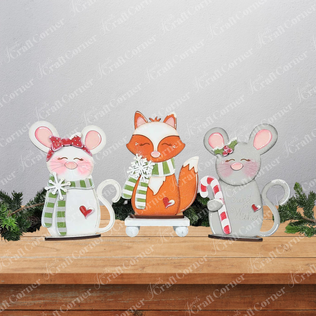Janet's Craft Corner Forest Friends Shelf Sitters—DIY seasonal decor kits featuring a pink-cheeked mouse, orange fox, and gray mouse—bring whimsical woodland charm to your home. Choose from three festive figurines for your shelf!.