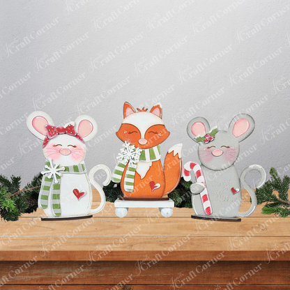 Janet's Craft Corner Forest Friends Shelf Sitters—DIY seasonal decor kits featuring a pink-cheeked mouse, orange fox, and gray mouse—bring whimsical woodland charm to your home. Choose from three festive figurines for your shelf!.