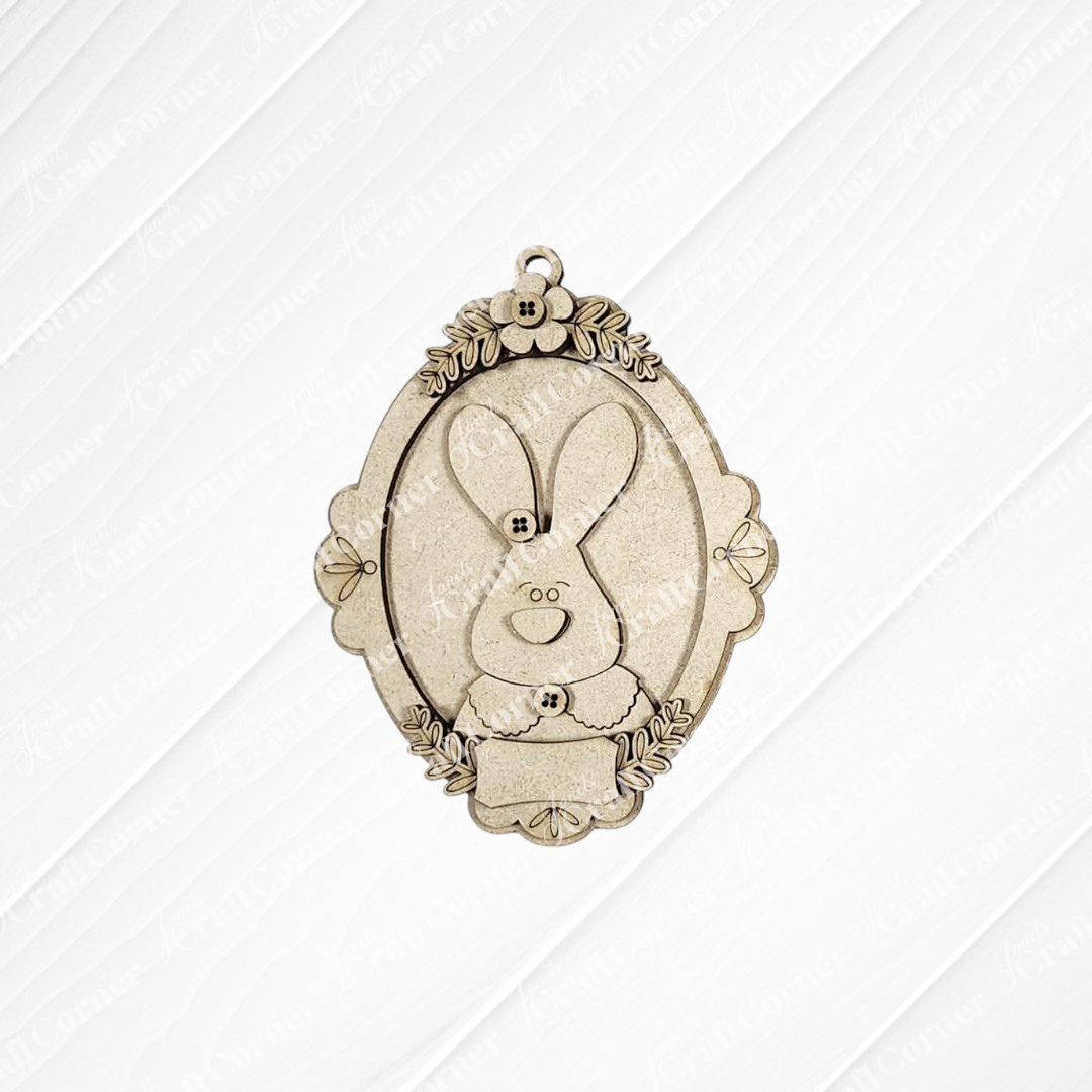Janet's Craft Corner Framed Easter Bunny Basket Tags feature a vintage, ornate oval design with a smiling cartoon bunny, floral accents, and a blank nameplate—perfect for personalizing Easter décor or baskets.