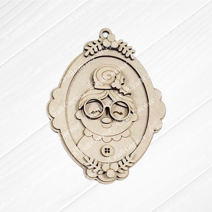 The Mrs. Claus Ornaments by Janet's Craft Corner feature an intricately engraved cartoon grandmother with glasses, bun, and flowers in a light wood finish—ideal for holiday decorations or DIY craft kits.