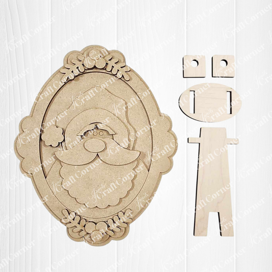 Janet's Craft Corner Framed Santa Shelf Sitter is a DIY seasonal home decor kit featuring an oval plaque with a layered Santa face and separate stand, perfect as a festive holiday decoration. Set of 1.