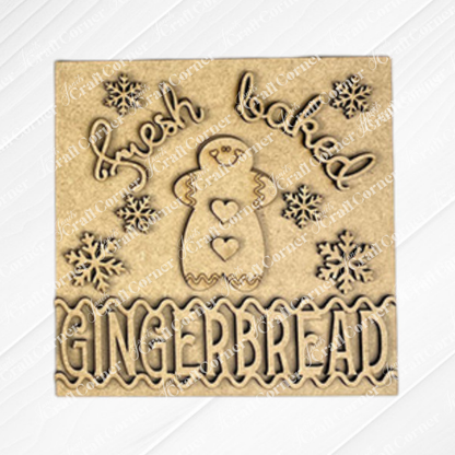 Janet's Craft Corner Gingerbread Squares are wood plaques for Swappable Square Displays, engraved with "Fresh baked GINGERBREAD," a gingerbread figure, and snowflakes—perfect for festive DIY seasonal home decor.