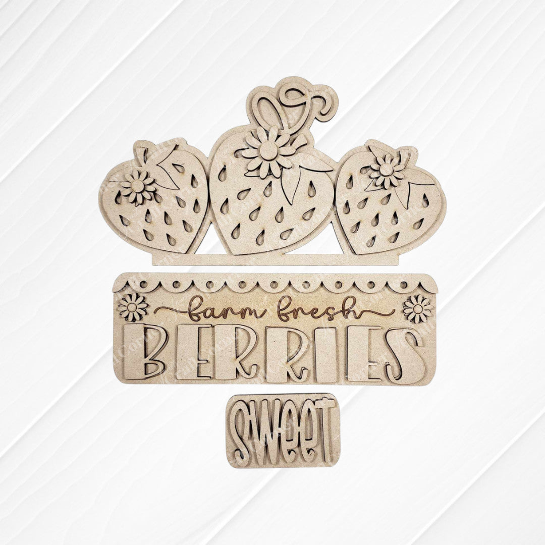 Janet's Craft Corner Fresh Berries Interchangeable Insert DIY kit includes 3 wooden pieces with strawberries, flowers, and engraved "farm fresh BERRIES" and "SWEET" on a white shiplap–style background—ideal for summer home decor.