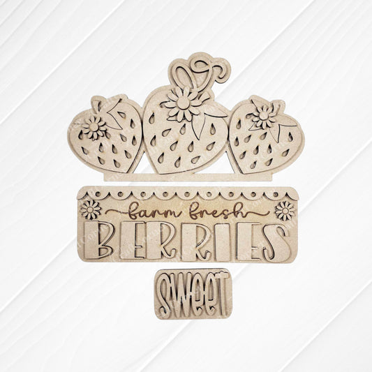 Janet's Craft Corner Fresh Berries Interchangeable Insert DIY kit includes 3 wooden pieces with strawberries, flowers, and engraved "farm fresh BERRIES" and "SWEET" on a white shiplap–style background—ideal for summer home decor.