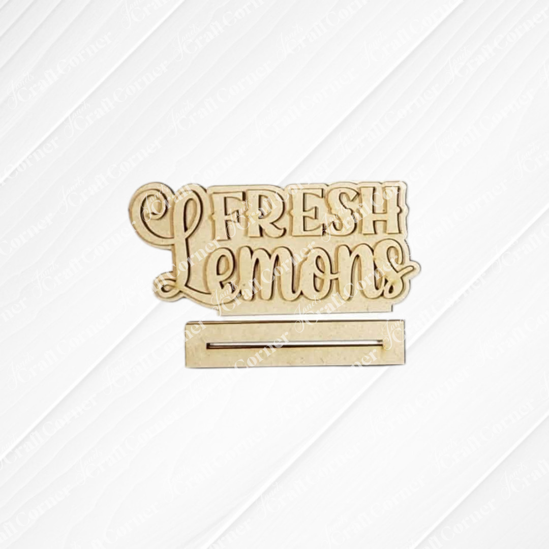 The Lemon Decor Set by Janet's Craft Corner features a gold "Fresh Lemons" sign with a horizontal slot on a white, textured background—ideal for bringing farmhouse flair to your DIY home decor projects.