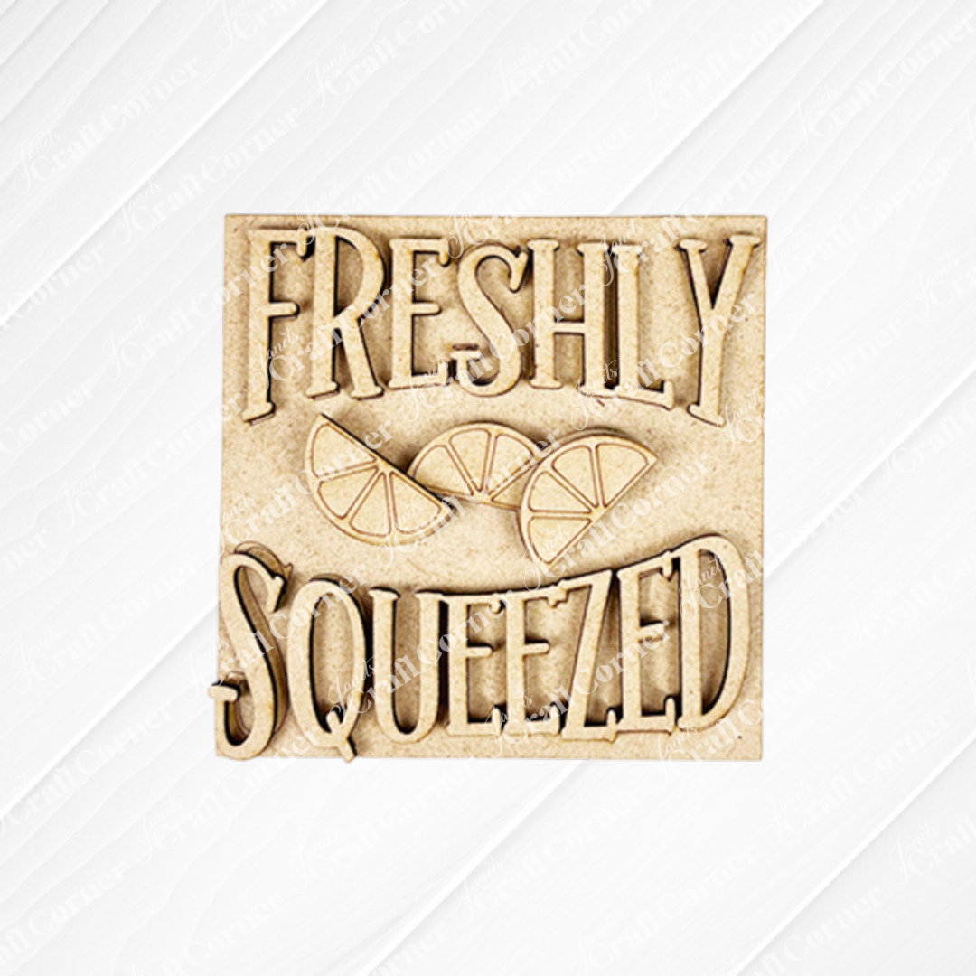 Janet's Craft Corner "Lemon Squares": A beige square sign with "FRESHLY SQUEEZED" in bold letters and three citrus slices, plus a subtle diagonal stripe background—ideal for Swappable Squares or DIY seasonal decor.