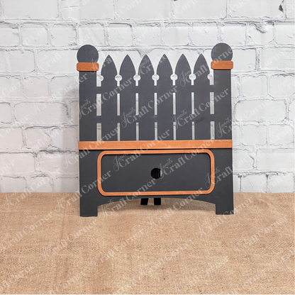 Janet's Craft Corner Garden Fence Interchangeable Base DIY home decor kit  shown painted black with stained accents  in front of a white brick wall.