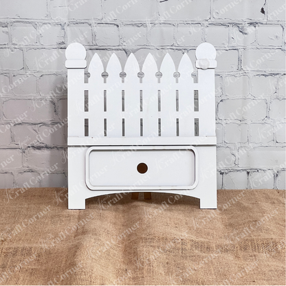Janet's Craft Corner Garden Fence Interchangeable Base DIY home decor kit  shown stained in front of a white brick wall.