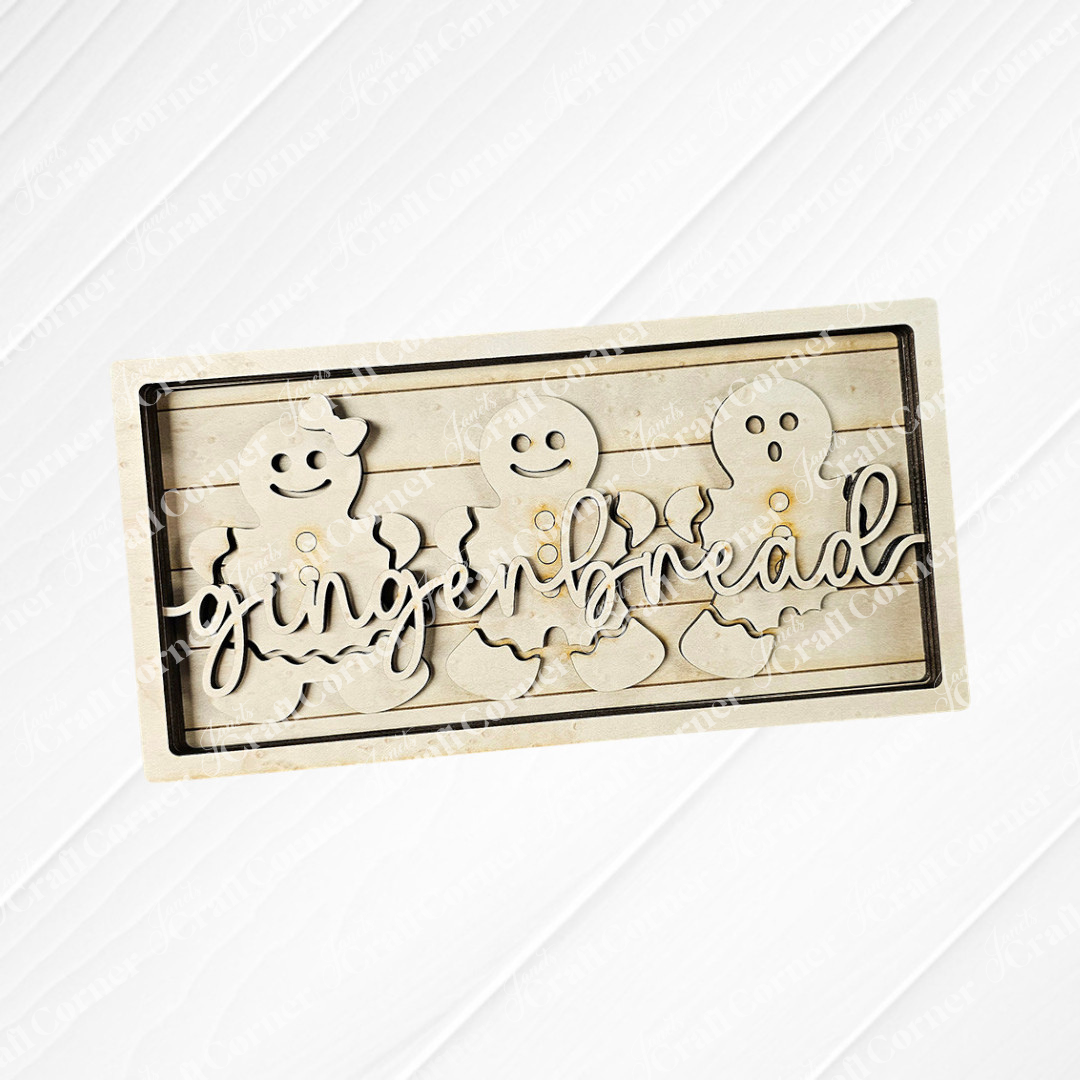 The delightful Gingerbread Chunky Shelf Sitter DIY Home Decor Kit by Janet's Craft Corner features a wooden piece with three gingerbread figures, smooth edges, and the word "gingerbread" elegantly displayed. Its rustic, light wood finish makes it a charming addition to any home décor.