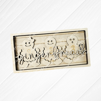 The delightful Gingerbread Chunky Shelf Sitter DIY Home Decor Kit by Janet's Craft Corner features a wooden piece with three gingerbread figures, smooth edges, and the word "gingerbread" elegantly displayed. Its rustic, light wood finish makes it a charming addition to any home décor.