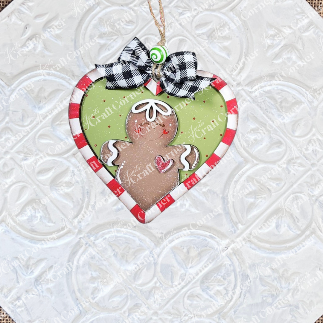 Janet's Craft Corner’s Gingerbread Ornaments - DIY holiday craft kit (Set of 8) features heart-shaped designs with gingerbread people, festive borders, plaid bows, and swirls—perfect for creative holiday décor and fun seasonal crafting.