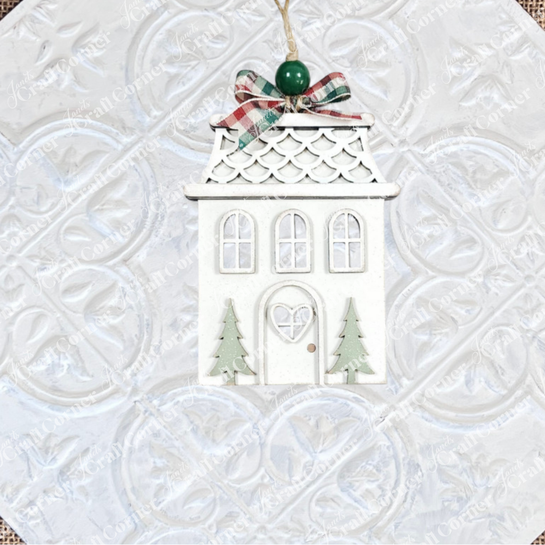 Add charm to your holiday décor with Janet's Craft Corner Gingerbread Ornaments DIY holiday craft kit—a set of 8 house-shaped ornaments featuring green trees, scalloped roofs, and plaid bows, ready for you to decorate and hang.
