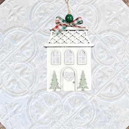 Add charm to your holiday décor with Janet's Craft Corner Gingerbread Ornaments DIY holiday craft kit—a set of 8 house-shaped ornaments featuring green trees, scalloped roofs, and plaid bows, ready for you to decorate and hang.