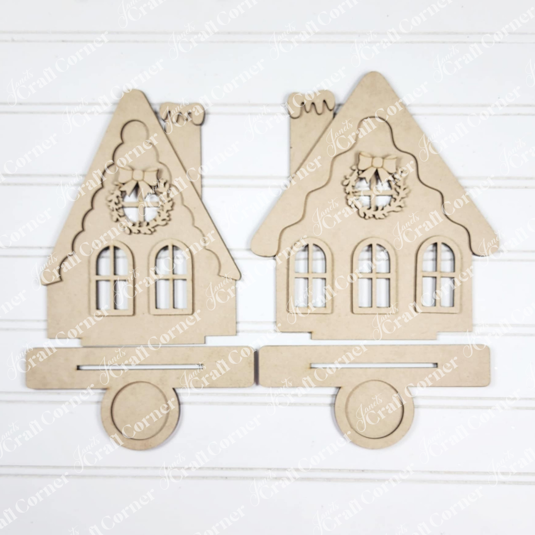 The Victorian Gingerbread House Votive Holder DIY craft kit from Janet's Craft Corner features unfinished wood, charming window and roof detailing, and is perfect for festive seasonal home decor as a standing display.