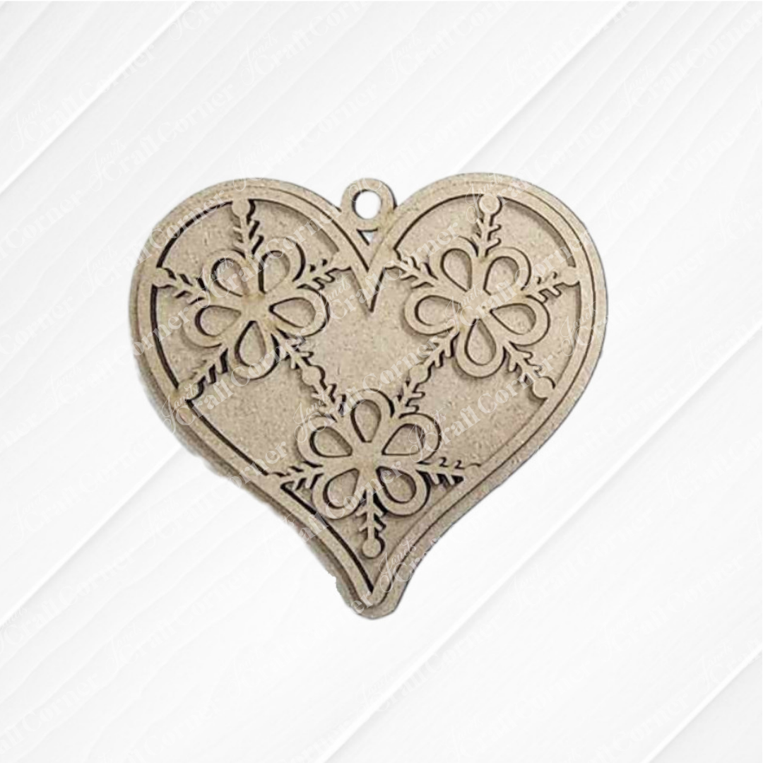 The Gingerbread Iced Cookie Ornaments DIY holiday craft kit by Janet's Craft Corner features six heart-shaped ornaments with floral designs, each with a top hole for hanging—ideal homemade Christmas tree decorations on a white textured background.