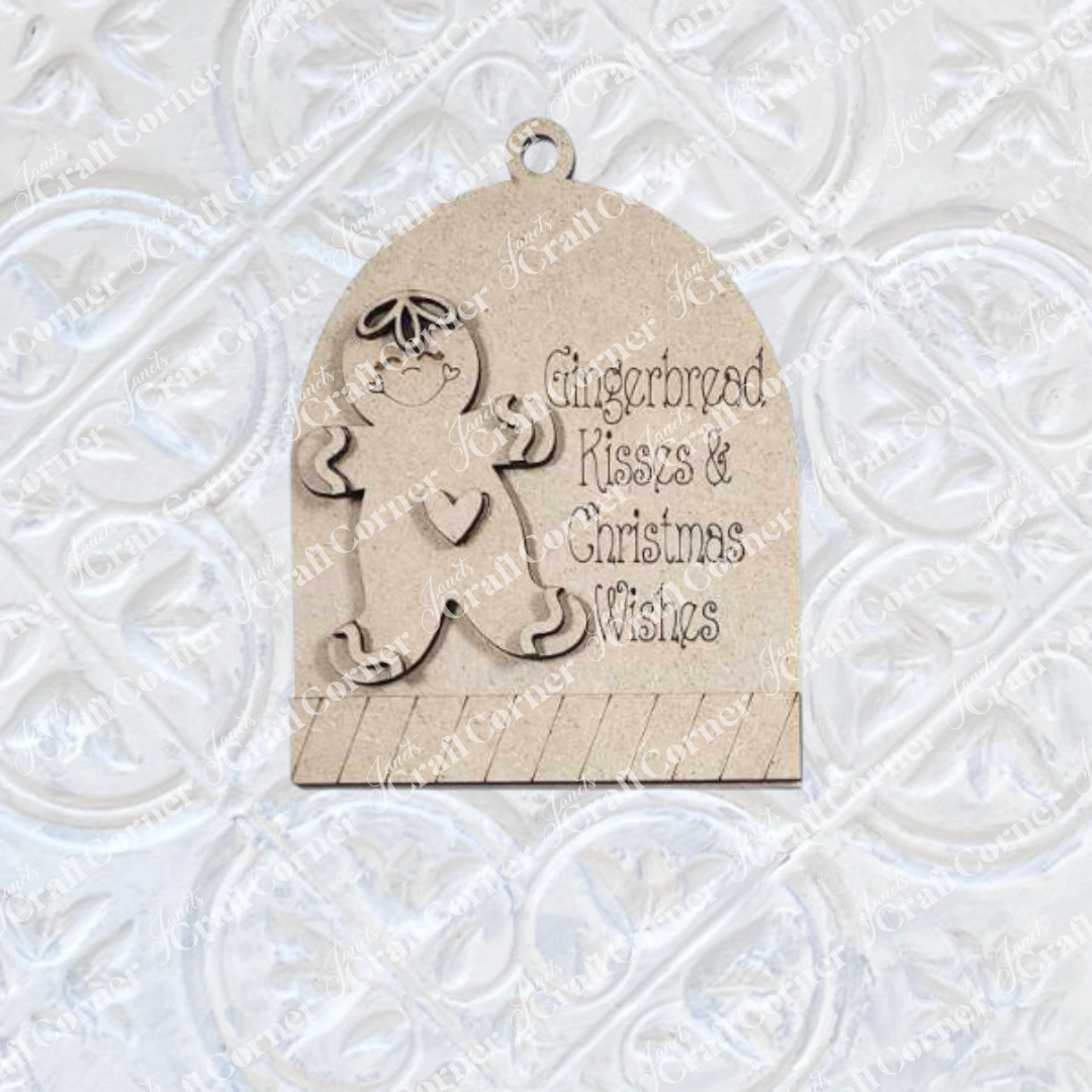 The Gingerbread Ornaments DIY holiday craft kit by Janet's Craft Corner includes 8 wooden ornaments featuring smiling gingerbread figures and “Gingerbread Kisses & Christmas Wishes” text—perfect for charming holiday décor.
